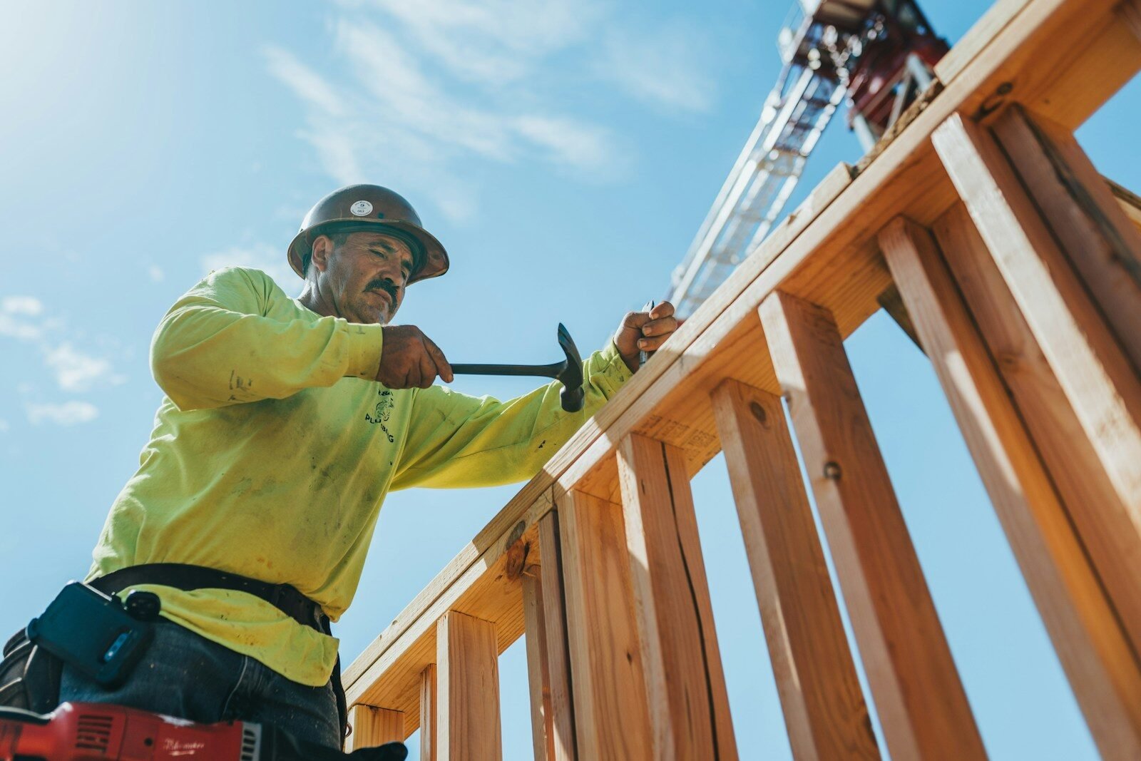 Worker building a wooden fence