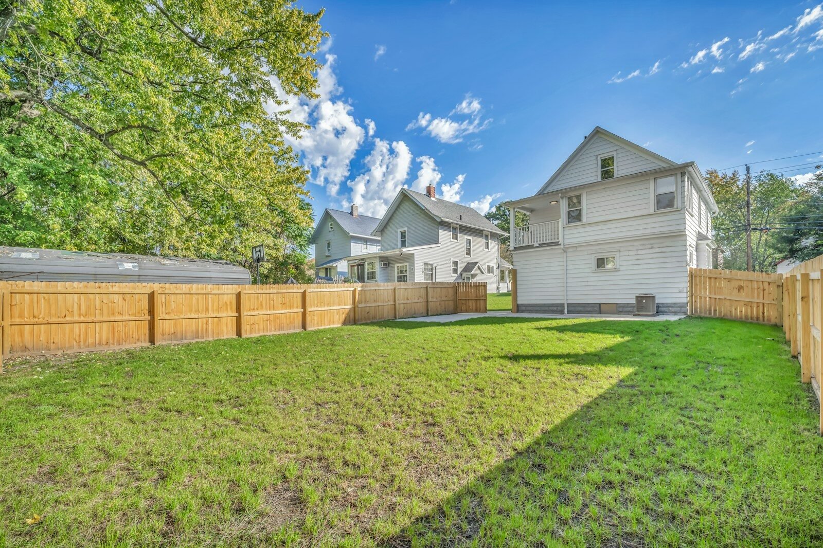 Wood privacy fence around a grassy backyard